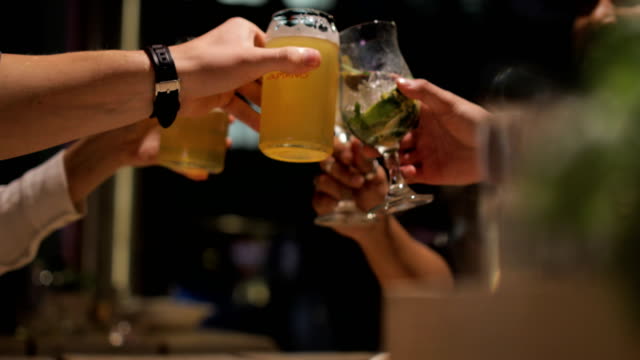 A medium sized group of friends enjoying a couple of drinks after work.